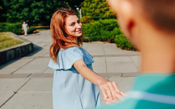 young woman leading a man by the hand