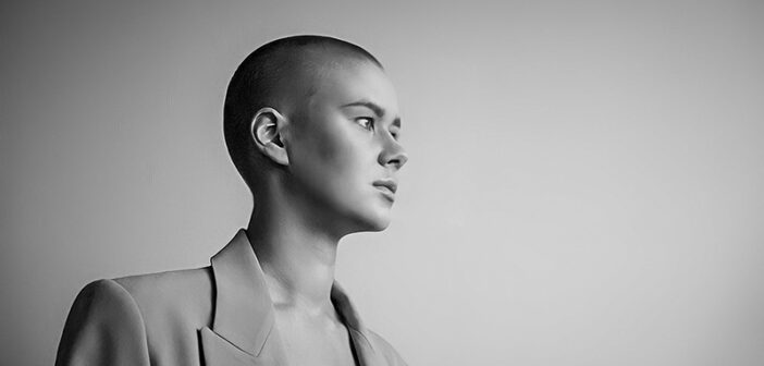 black and white photo of a bored looking bald woman - illustrating a stagnant life