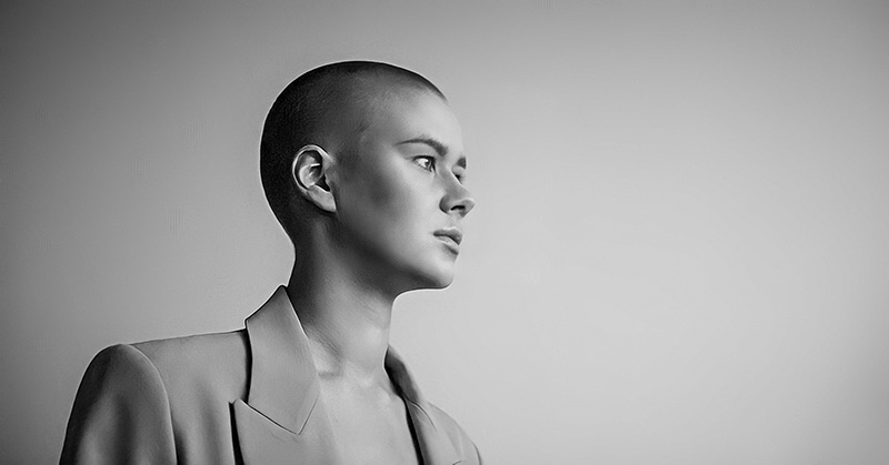 black and white photo of a bored looking bald woman - illustrating a stagnant life