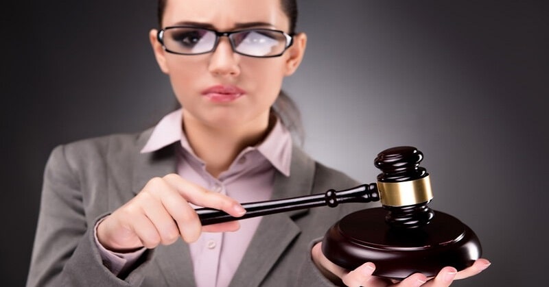 woman with gavel - illustrating judgmental people