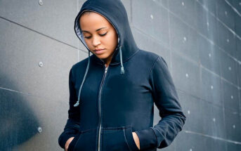young woman in a hoodie looking sad after things didn't go her way