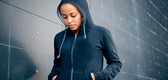 young woman in a hoodie looking sad after things didn't go her way