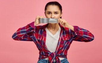 woman putting tape across her mouth to illustrate keeping your mouth shut