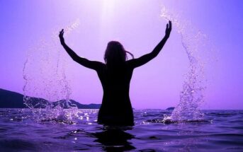 woman splashing in sea - illustrating valuing yourself