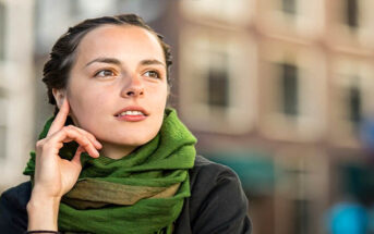 young woman looking thoughtful - illustrating a fair-minded person