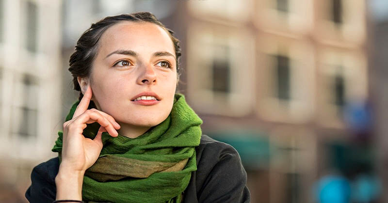 young woman looking thoughtful - illustrating a fair-minded person