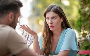 woman sitting opposite husband who misinterprets everything she says