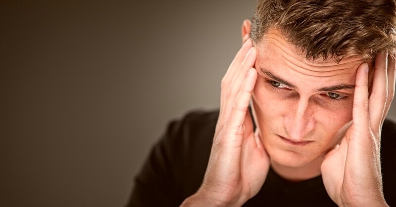 emotional constipation - man looking stressed by keeping his emotions in