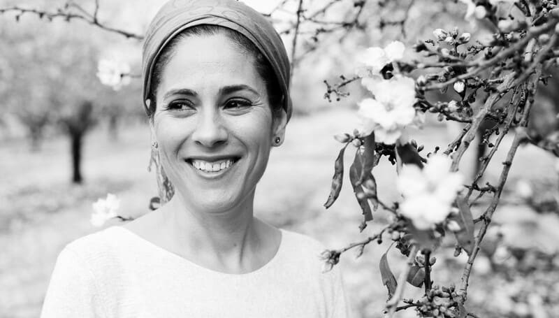 smiling woman next to tree who is finally living for herself