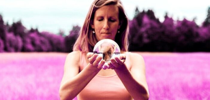 woman holding a crystal ball symbolizing her peace that she's protecting