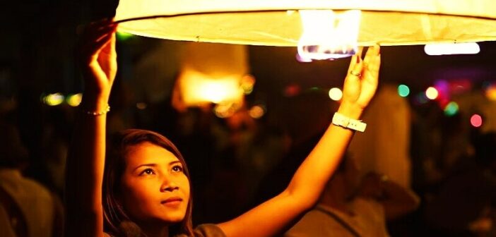 law of detachment - woman releasing floating lantern