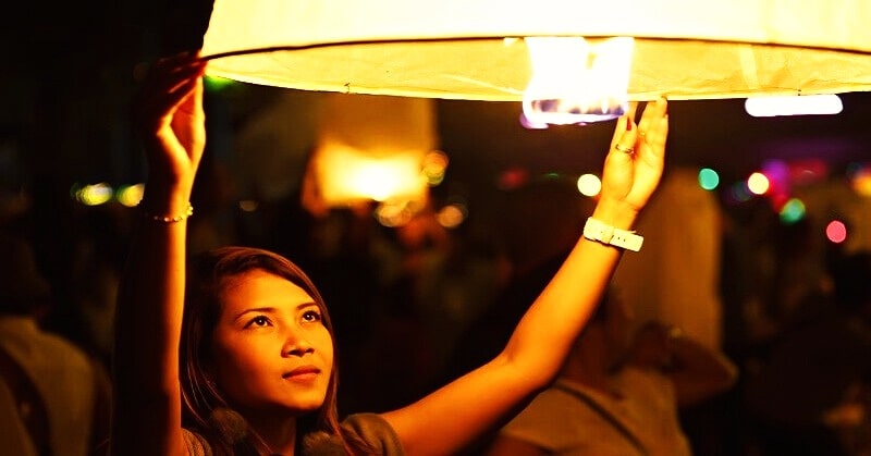 law of detachment - woman releasing floating lantern