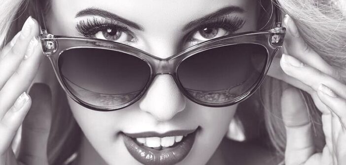 how to know if a girl is playing you - seductive woman looking over top of her sunglasses