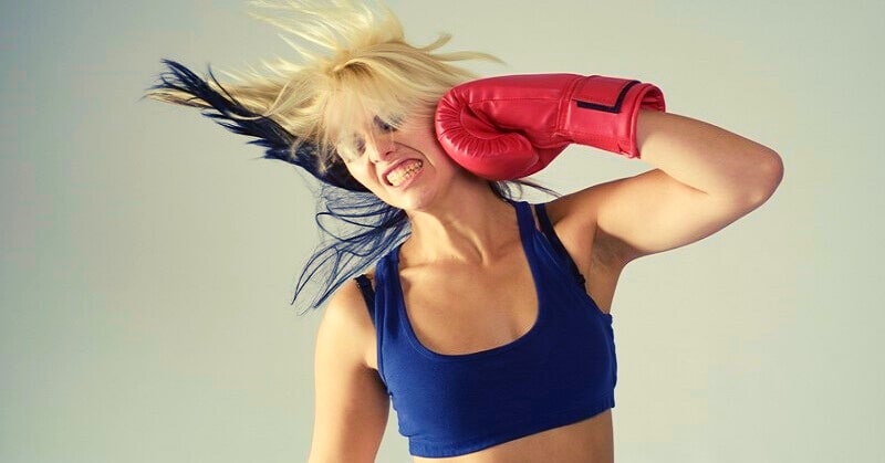 self-punishment - woman hitting herself in the face