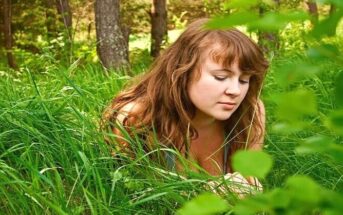 loving someone you can't be with - young woman looking forlorn amongst grass