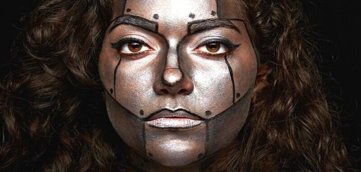 how to be emotionless: woman with robot face paint