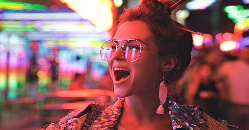 young woman in sequin top being unapologetically herself