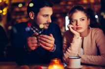unhappy looking couple in bar