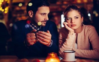unhappy looking couple in bar