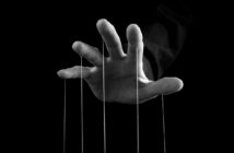 hand with strings coming from fingers indicating a controlling man