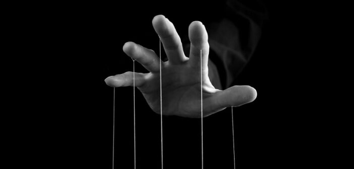hand with strings coming from fingers indicating a controlling man