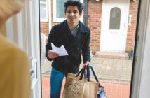 young man doing a kind thing by delivery groceries to elderly neighbor