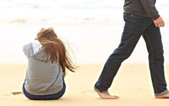 man walking away from his girlfriend on a beach