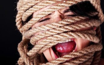 screaming woman with rope tied around her head and face illustrating having lost control of her thoughts