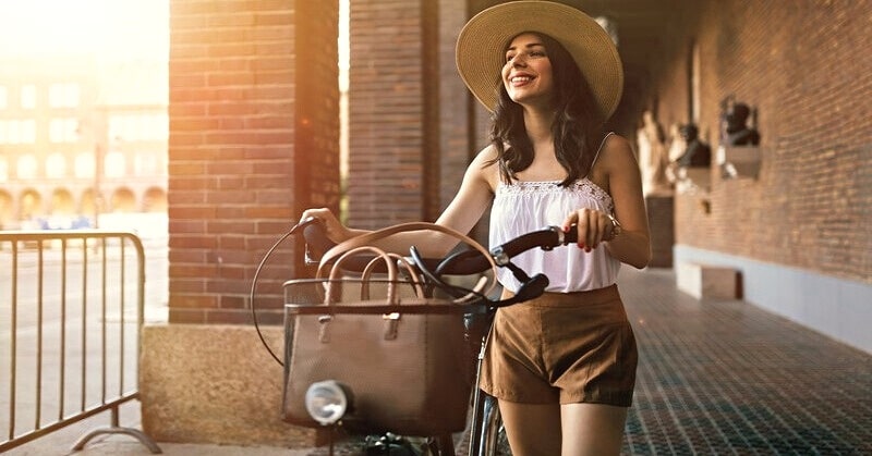 young woman with bike enjoying her own company