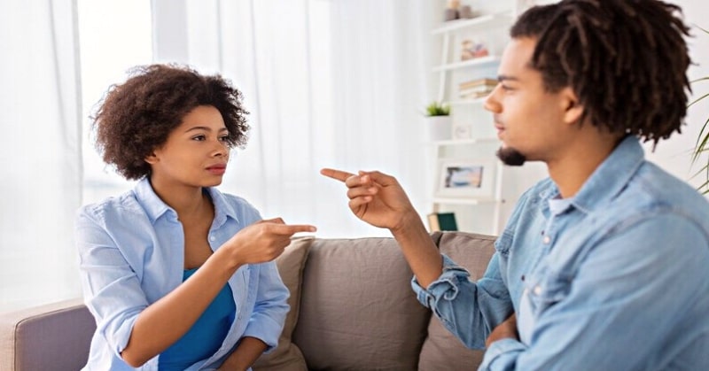 couple pointing fingers at each other illustrating nitpicking in a relationship
