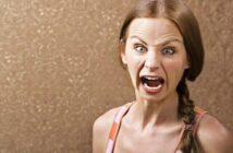 woman with extreme angry face illustrating an overreaction