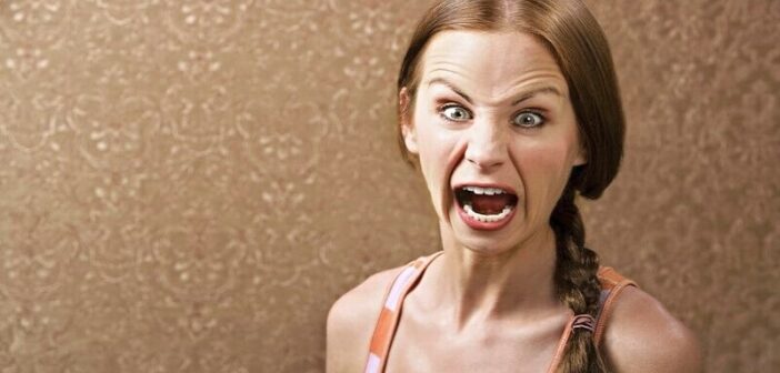 woman with extreme angry face illustrating an overreaction
