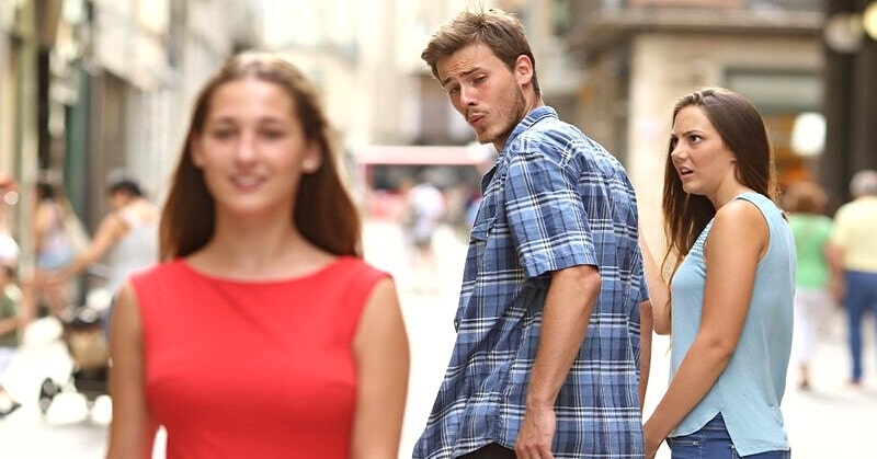 boyfriend looking at another woman on the street