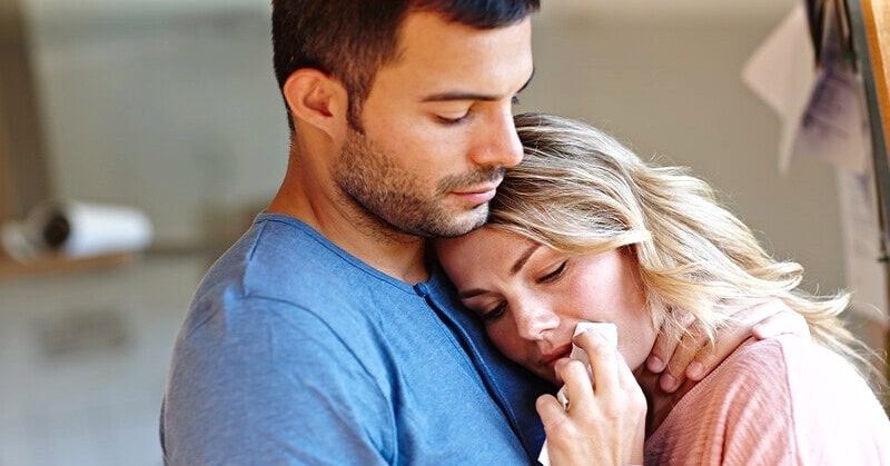 man showing care for sad girlfriend