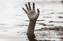 hand of drowning person coming out of water