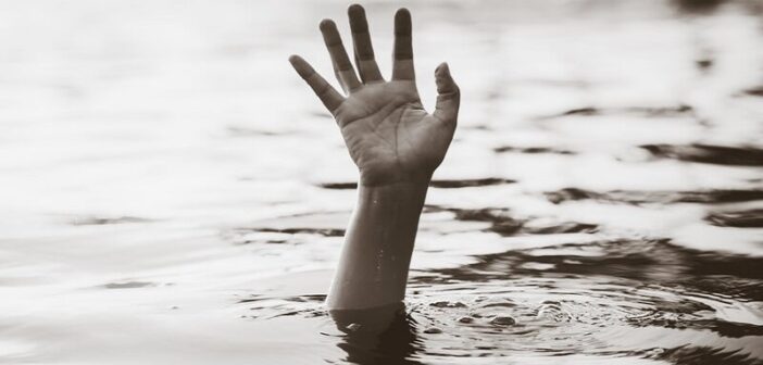 hand of drowning person coming out of water