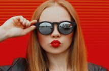 woman with sunglasses puckering her lips