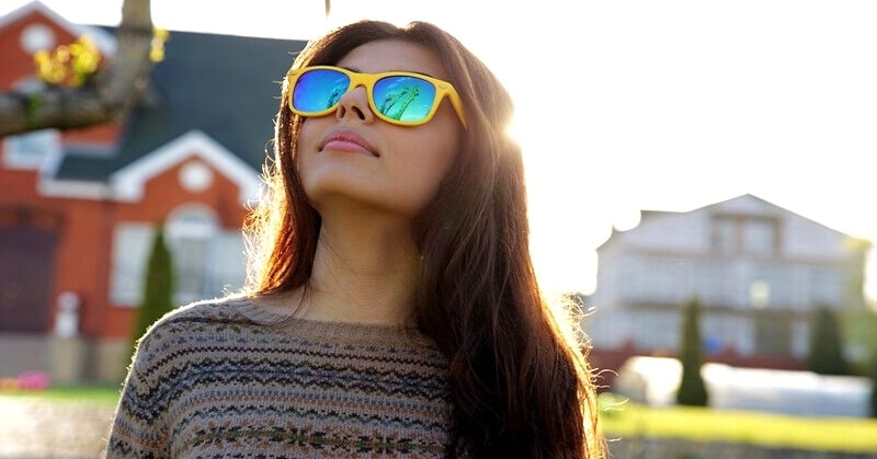 cool young woman with quirky yellow sunglasses