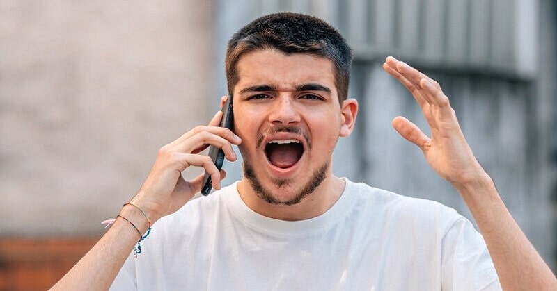 man shouting down the phone saying things he doesn't mean