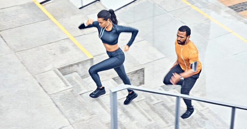 man and woman running up steps outside - illustrating disciplined people