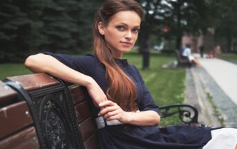 classy woman sitting on a park bench