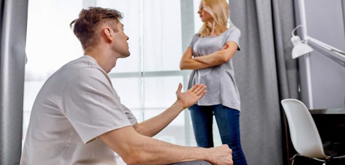 man saying something unkind to his girlfriend