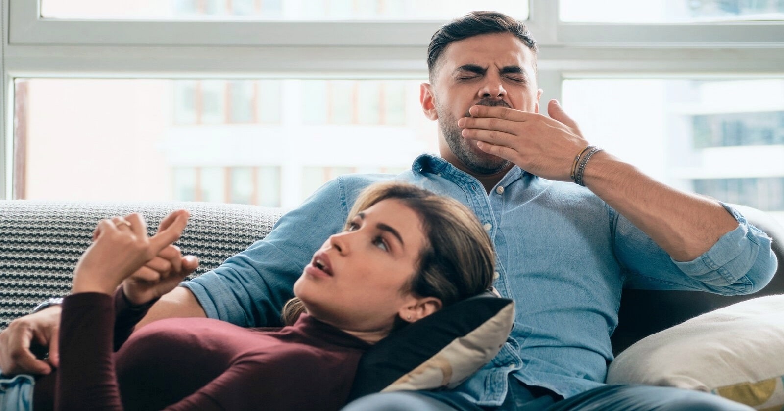 man yawning as his partner talks a lot