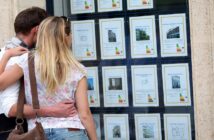 couple looking at real estate listings but they want to live in different places