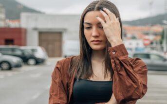 pensive serious woman with emotional baggage