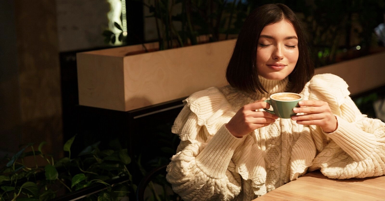 woman with eyes closed holding coffee - illustrating being in tune with yourself