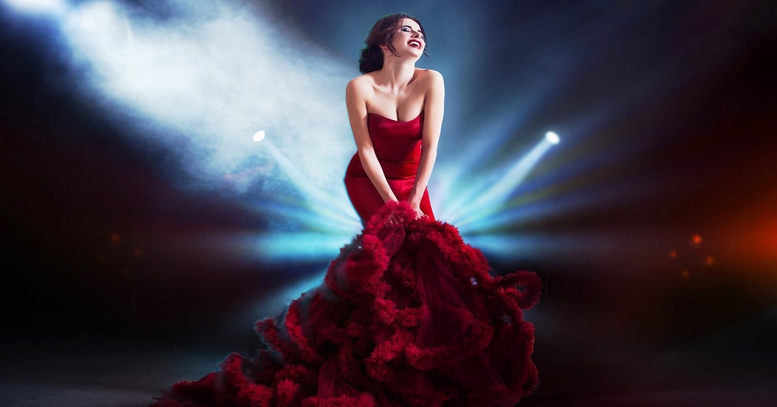 woman in striking red dress standing in several spotlights - illustrating an attention-seeker