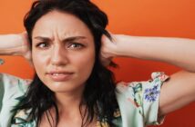 11 Things To Do Instead Of Complaining About Your Problems woman with hands over her ears because she's fed up of listening to someone complain