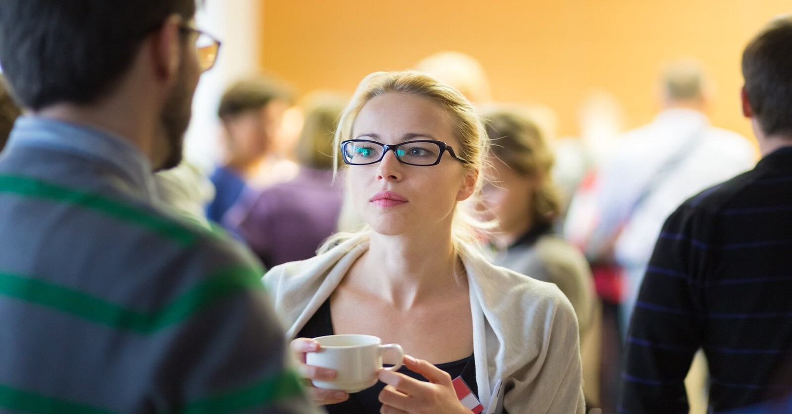 man and woman engaged in small talk at a conference