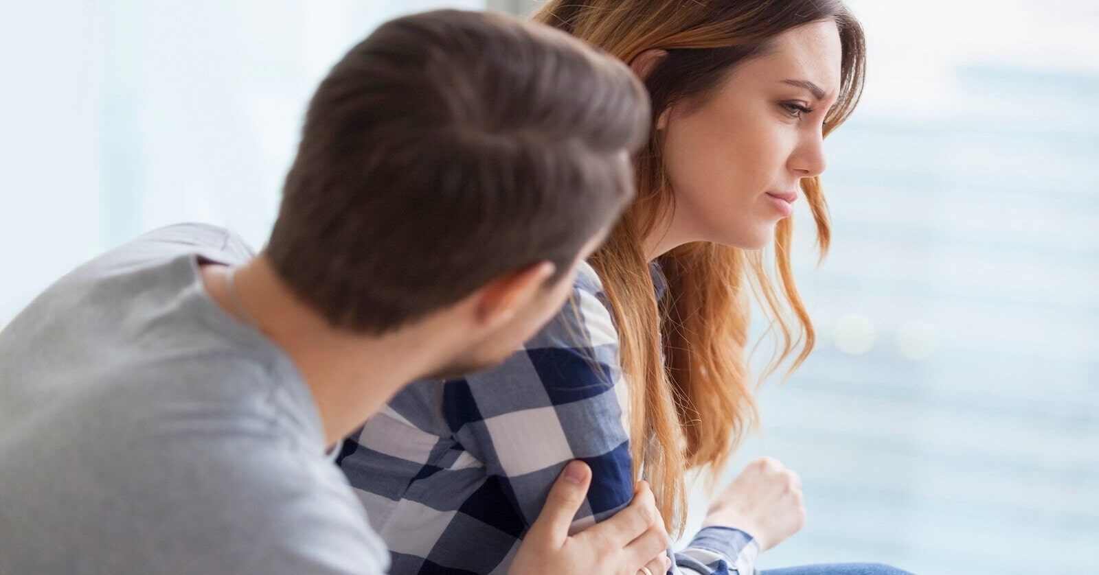 man showing concern for his girlfriend after hurting her emotionally